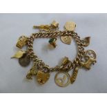 9ct gold charm bracelet with fifteen gold charms and a silver 3d coin, approx total weight 27.8g
