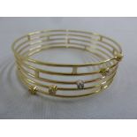 Yellow gold and diamond five strand bangle, gold tested 18ct, approx total weight 32.1g