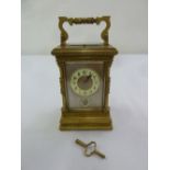 A brass repeating carriage clock with subsidiary second hand and scroll carrying handle