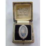 An antique 18ct and platinum dress ring with inset portrait of a lady