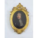 An 18th century framed miniature portrait of a gentleman by Rigaud, 15 x 9.5cm