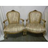 A pair of French upholstered armchairs on turned tapering cylindrical legs
