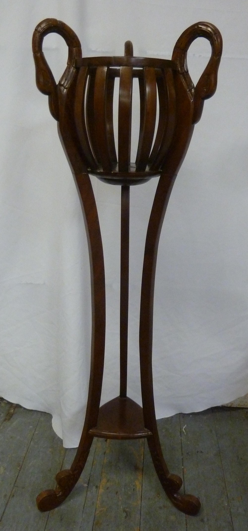 Mahogany plant stand with swan handles and three curved supports