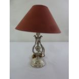 A silver plated Victorian style table lamp on raised circular base to include shade