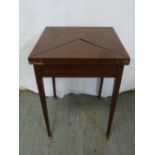 An Edwardian mahogany envelope games table on four tapering rectangular legs with brass castors
