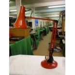 A red Model 90 anglepoise lamp