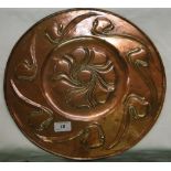 An Arts & Crafts stylised copper plaque with flowerhead centre