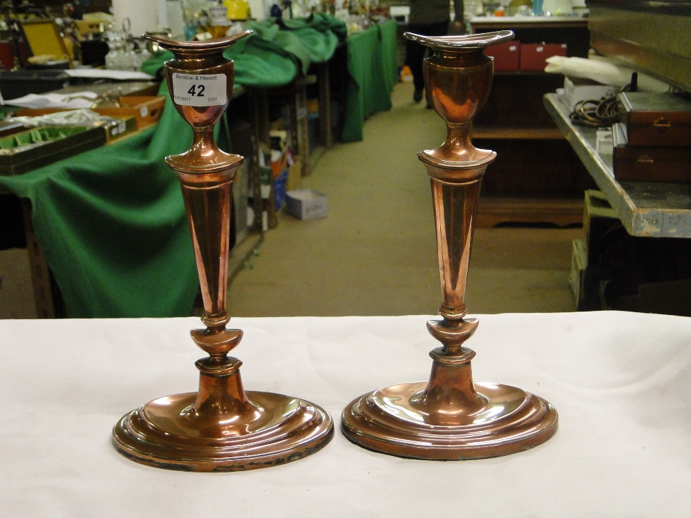 Pair of antique copper candlesticks on oval plinth bases