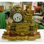 A 19th century French gilded spelter mantel clock surmounted by a classical figure on giltwood