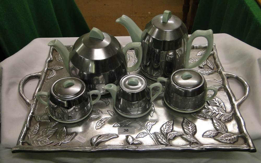 A 5 piece 1930s Heatsaver tea set with metal covers,