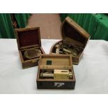 2 reproduction brass instruments in wooden cases,