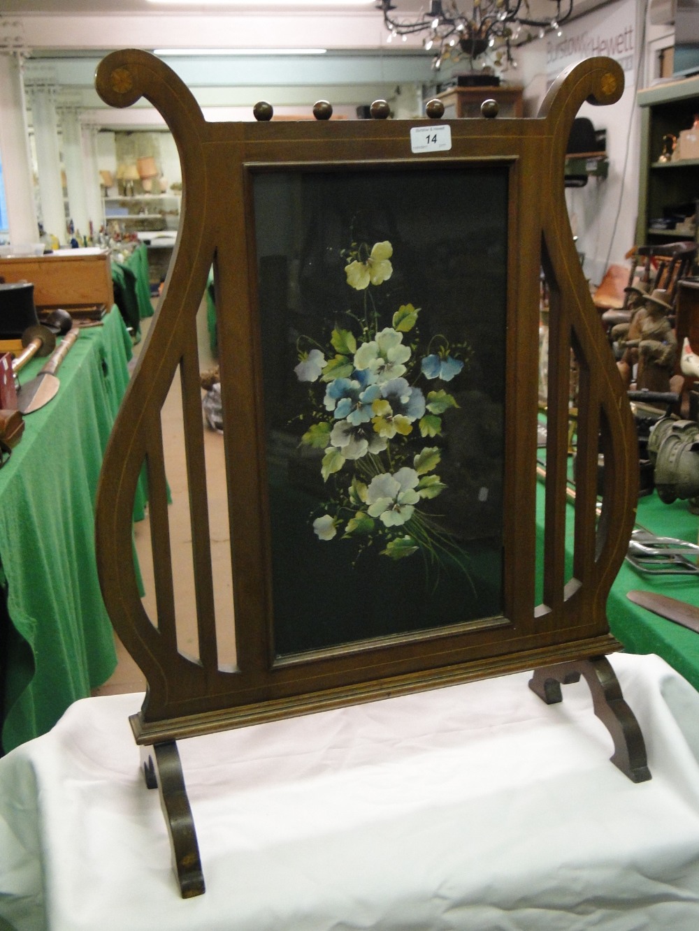 An Edwardian lyre shape inlaid mahogany firescreen, with painted panel of pansies, height 27.5".