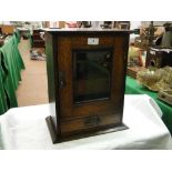 An oak smokers cabinet with fitted interior,