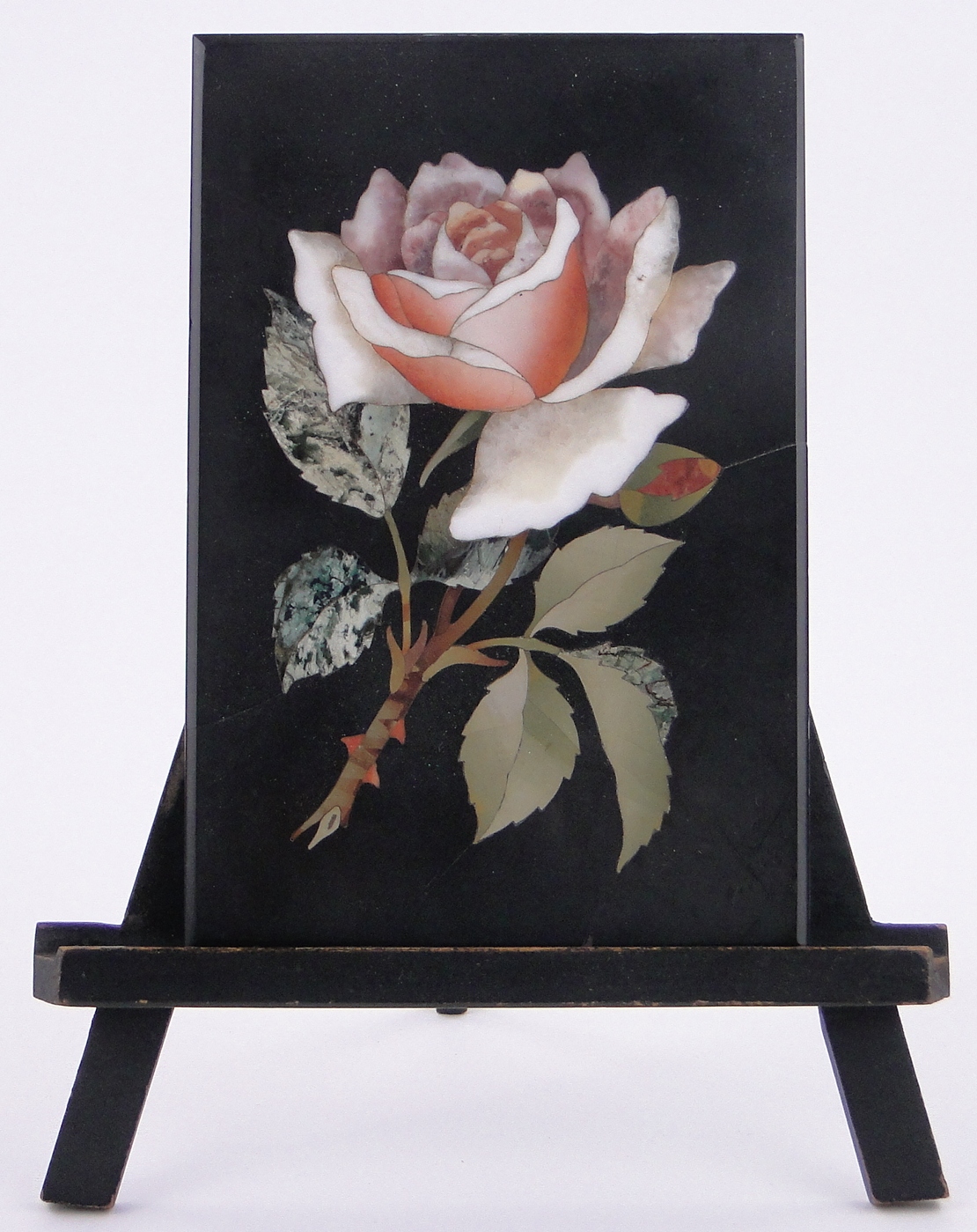 A Victorian pietra-dura specimen hardstone rose design plaque, 7" x 4.75", mounted on wooden easel.