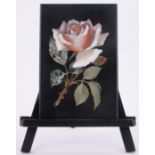 A Victorian pietra-dura specimen hardstone rose design plaque, 7" x 4.75", mounted on wooden easel.