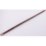 A Chinese red and green lacquered walking cane, with embossed silver top, length 37.5".