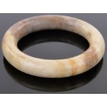 A Chinese pale brown jade bangle, inside diameter 2.75".