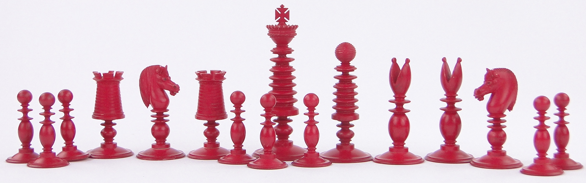 A Victorian red and white stained ivory chess set, by Fisher, 188 Strand, London, King height 3.25".