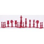 A Victorian red and white stained ivory chess set, by Fisher, 188 Strand, London, King height 3.25".