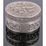 A Chinese circular silver box, with relief bird and floral designs, diameter 5.5 cm.