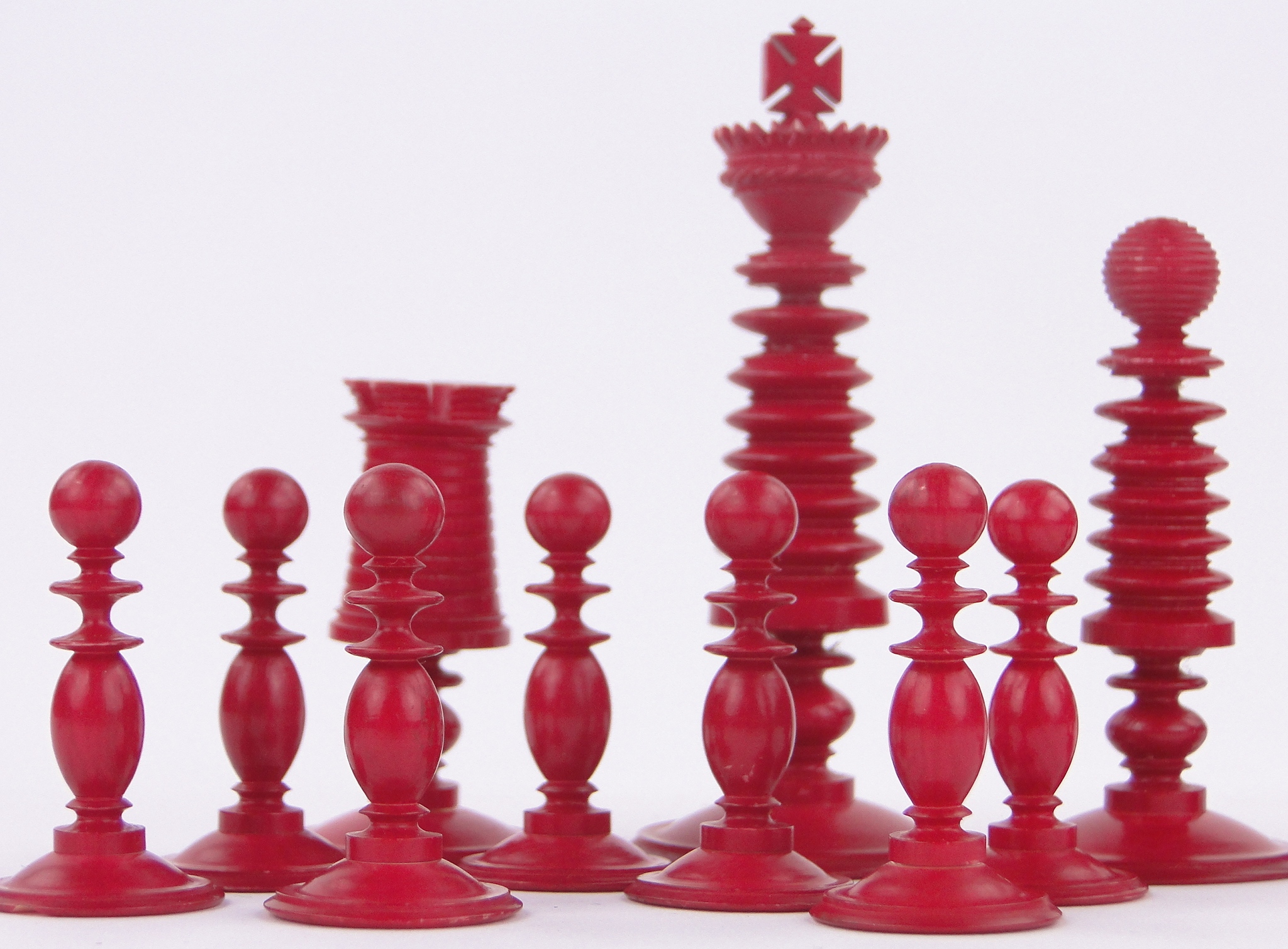 A Victorian red and white stained ivory chess set, by Fisher, 188 Strand, London, King height 3.25". - Image 3 of 3