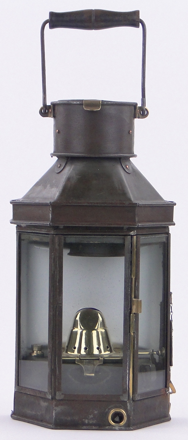 A Victorian metal framed coach lantern, with brass mounts and swing handle,