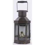 A Victorian metal framed coach lantern, with brass mounts and swing handle,