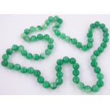 A long string of Chinese green hardstone beads.