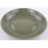 A large Chinese celadon glazed bowl, with incised leaf designs, diameter 18.25".