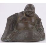 An Oriental patinated metal reclining Buddha, height 5".