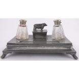 A Victorian pewter desk stand, with cut-glass milk churn shaped inkwells, length 12".