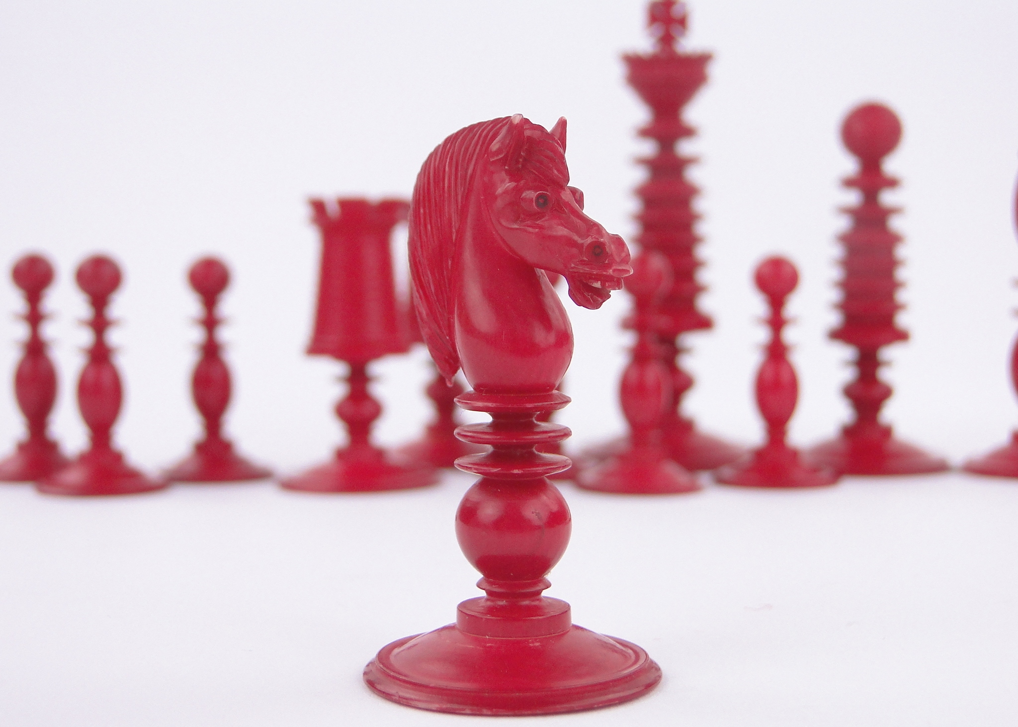 A Victorian red and white stained ivory chess set, by Fisher, 188 Strand, London, King height 3.25". - Image 2 of 3