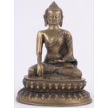 An Oriental bronze seated deity, on lotus base, height 11".