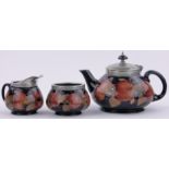 A Moorcroft Pomegranate pattern 3-piece teaset, hammered pewter mounts,