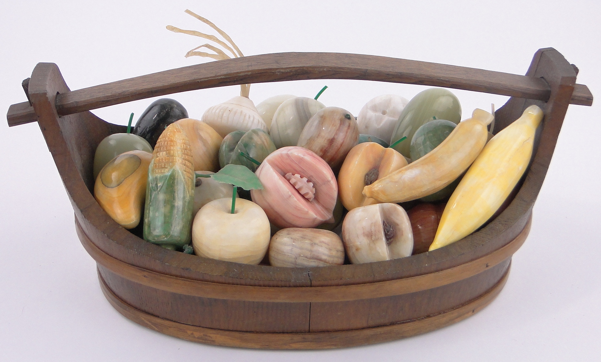 A large Collection of carved coloured stone ornamental fruit in wooden bound Scandinavian style
