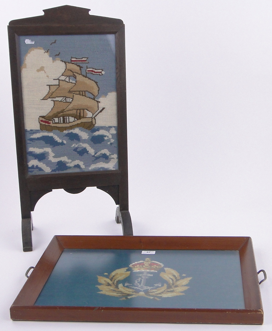 A mid 20th century walnut framed tea tray with inset woolwork naval crest,