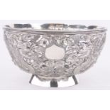 An ornate Chinese circular silver bowl circa 1900, with pierced chased dragon decorated side,