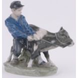 A Royal Copenhagen porcelain boy with calf, height 6.5".