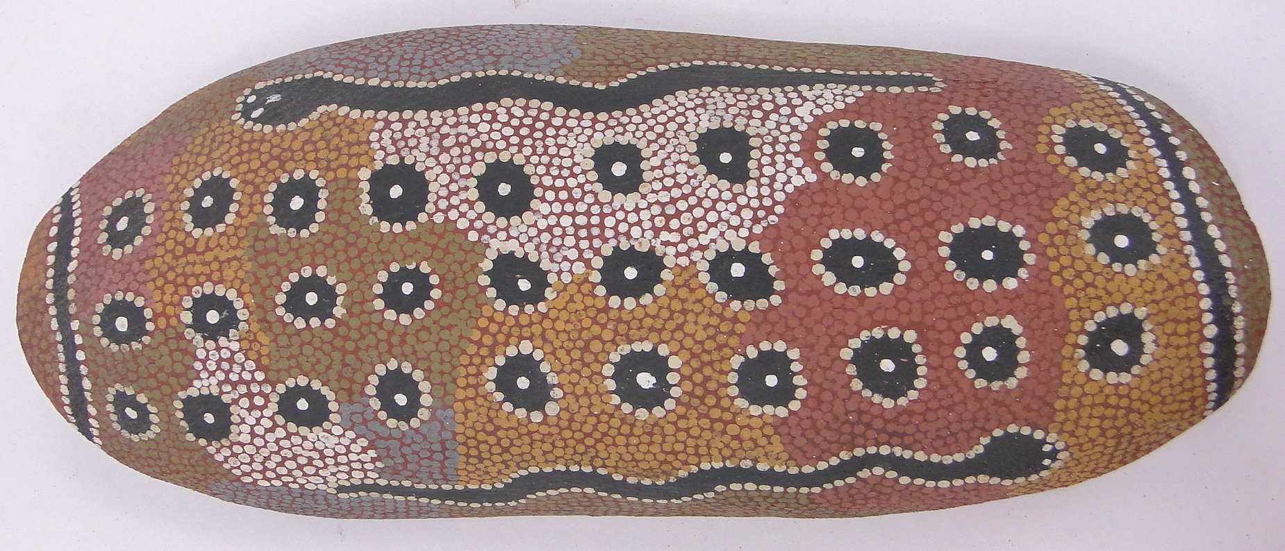 An Australian Aboriginal wood wall hanging, with painted snake designs, length 15.5".