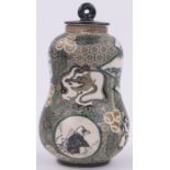 An Oriental double gourd vase and cover of small size, with painted panels on geometric ground,