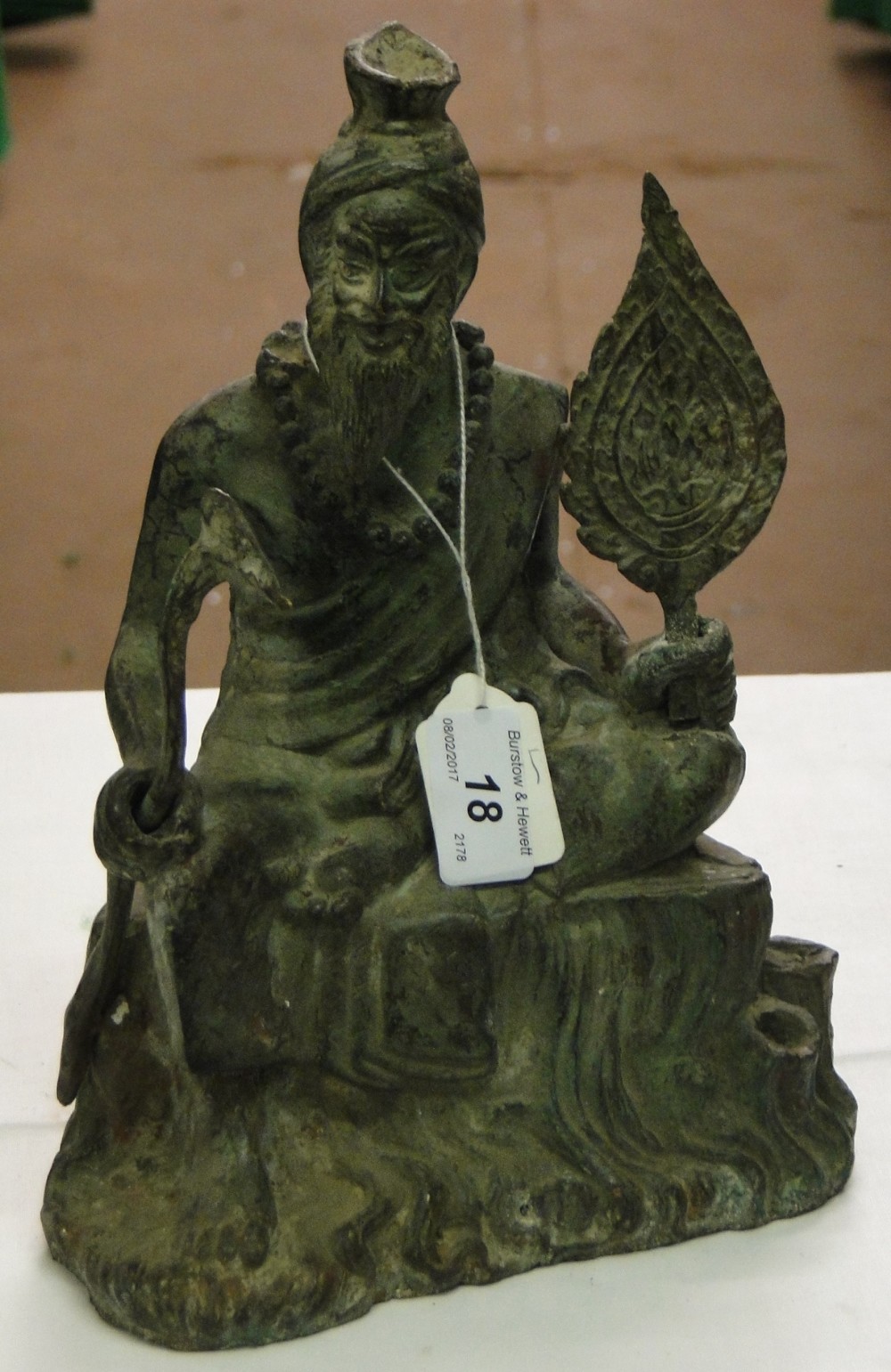 A Chinese verdigris bronze seated figure of a man, height 10.75".