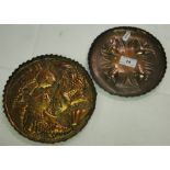 An Arts & Crafts copper dish with embossed design of flying bats and another with design of fish.