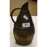 A continental coopered oak wine jug with copper bands.