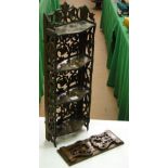 A Black Forest narrow small carved shelf with foliate design and a carved extending table top book