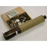 A box of coins and banknotes and a Vintage brass telescope.