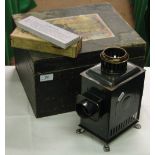 A Bing magic lantern with various slides in case.