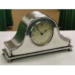 A German 8-day mantel clock in silver plated case.