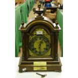 An Edwardian oak cased mantel clock by Hallett of Hastings with Presentation plaque dated 1907.