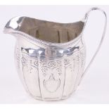 A George III silver cream jug, with engraved decoration, London 1799.