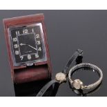 A Le-Coultre leather cased 8-day travelling clock, black dial with luminous numerals, case width 6.